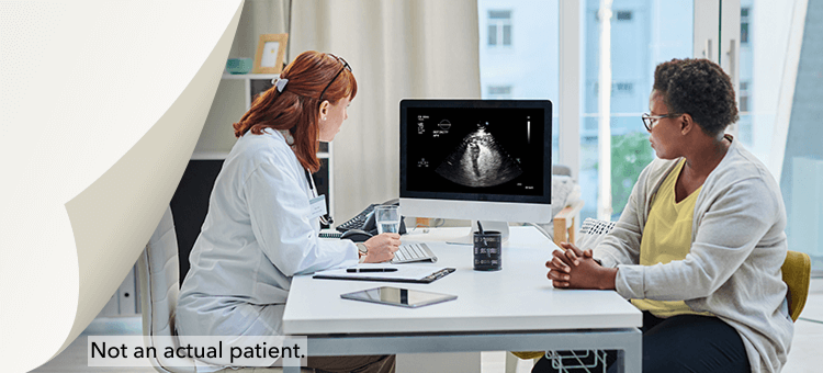 Improving Cardiac Diagnosis and Patient Management with DEFINITY® A Healthcare professional discussing ultrasound results to a patient, highlighting the efficacy of DEFINITY® in a clinic setting