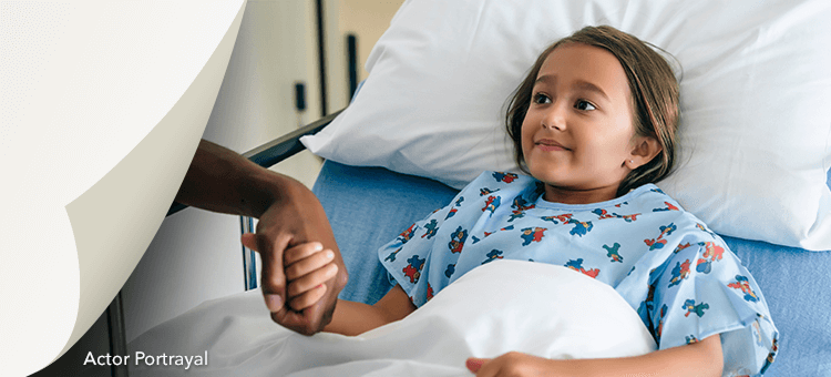 Young patient in a hospital bed under observation, illustrating the safety profile of DEFINITY®
